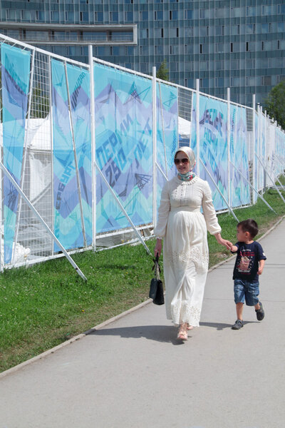 PERM, RUSSIA - JUN 13, 2013: Woman with son at festival White Ni
