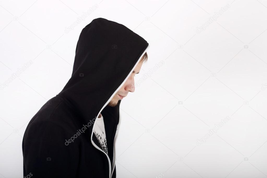 Profile of young man in black hoodies looking away in studio