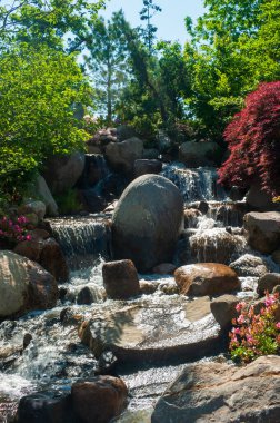Beautiful small waterfall in a japanese style garden