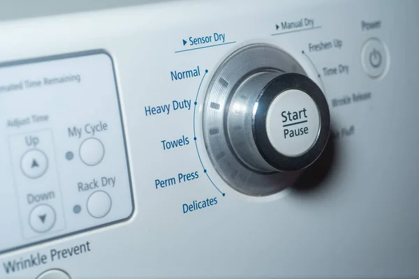 Selective focus on the start button on electric dryer — 图库照片