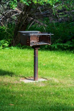 Public Barbecue or BBQ Grill in a public park on a sunny day. High quality photo