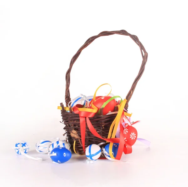 Basket with easter eggs on white background — Stock Photo, Image