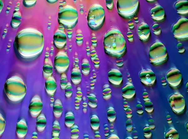 Waterdruppels op kleurrijke oppervlak — Stockfoto