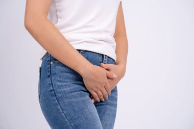 Woman has pain in the genital area and vagina on a white background.
