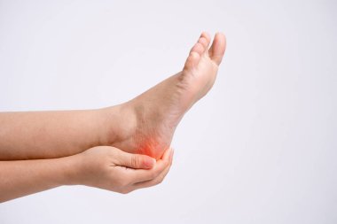 Photo of a woman's hands touching heels on a white background