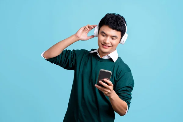 Asian Handsome Man Listening Music Isolated Light Blue Background — Stockfoto