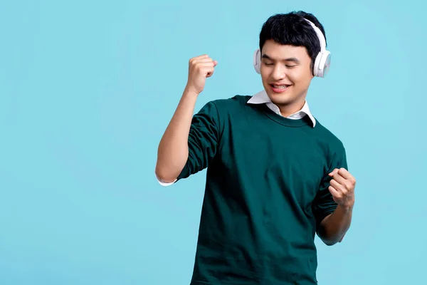 Smiling Young Handsome Asian Man Listening Music Cellphone Using Earbuds — Stockfoto