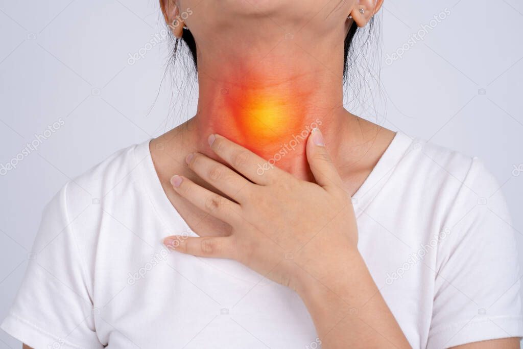 Woman with pain in the throat on a white background She has tonsils.