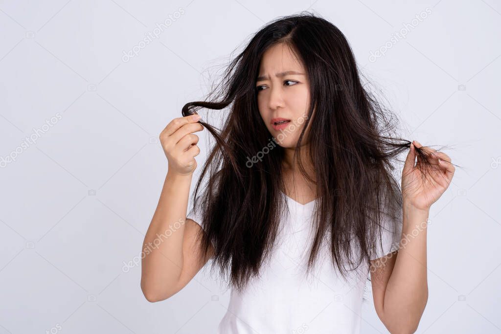 Sad Asian woman have hair problem.