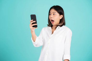 Beautiful Asian woman. She feels shocked with the phone