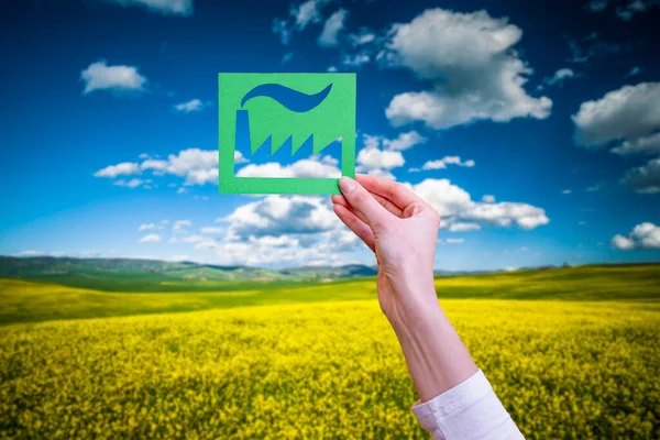 Hand holds green industry symbol — Stock Photo, Image