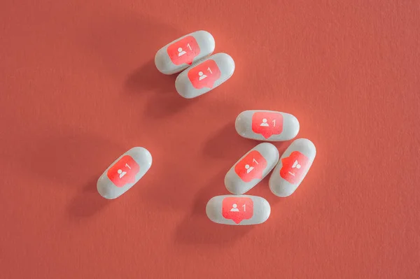 White pills with social media symbols — стоковое фото