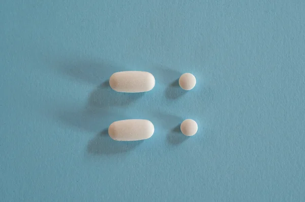 Closeup of with pills on blue background — Stock Photo, Image
