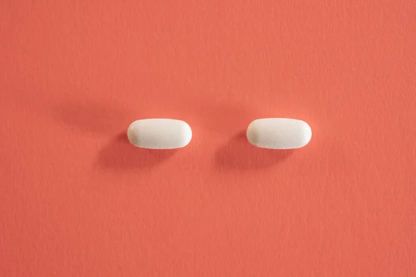 Closeup of with pills on red background — Stock Photo, Image