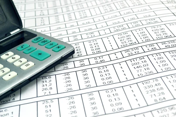 Numbers on paper and calculator — Stock Photo, Image