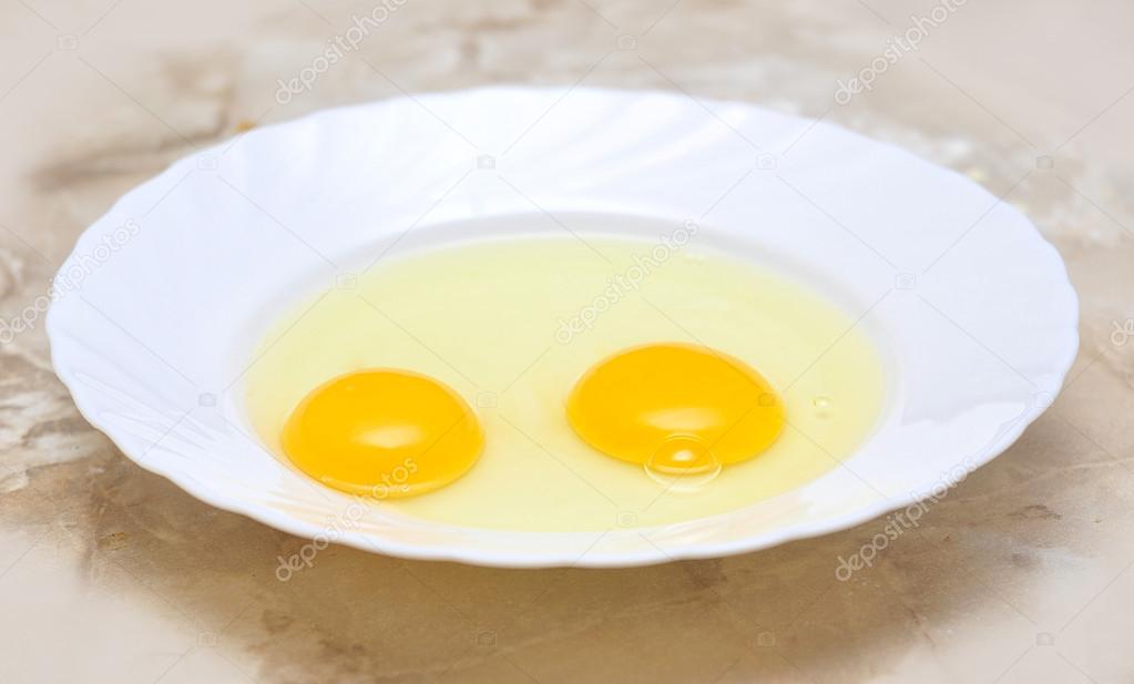 two eggs lying on the plate