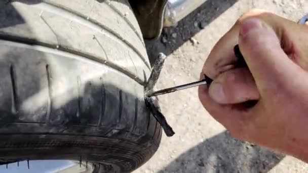 Male Hands Fixing Puncture Wheel Road Using Adhesive Broken Wheel — Stock Video