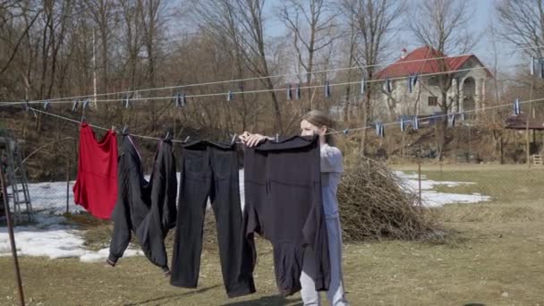 Woman Carefully Hangs Her Laundry Backyard Her House Housekeeping Work — Stock Video