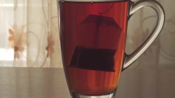 Dip Tea Bag Boiling Water Which Poured Glass Tea Cup — Vídeo de Stock