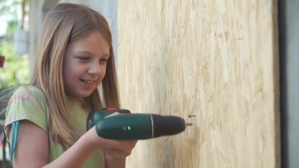 Uma Menina Idade Escolar Tenta Usar Uma Chave Fenda Elétrica — Vídeo de Stock