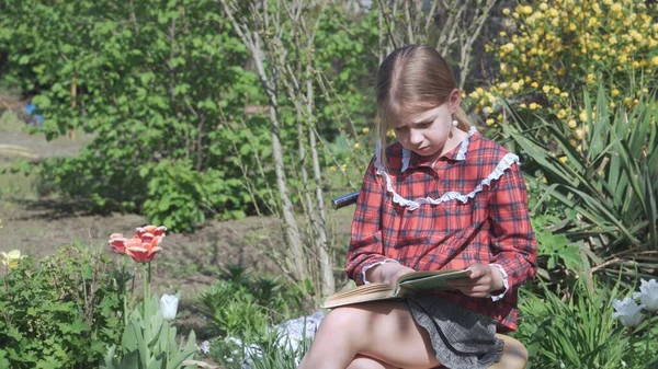 Een Negenjarig Meisje Schooluniform Zit Tuin Leest Zorgvuldig Een Boek — Stockfoto