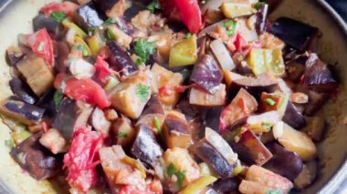 Hot dish of baked vegetables in frying pan. Steam and aroma rise above surface. Healthy vegan food.
