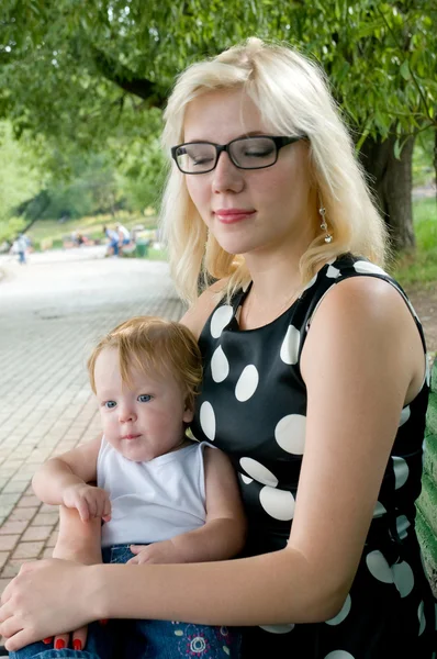 Portrait thoughtful girl with closed eyes and a two year old child — Stock Photo, Image