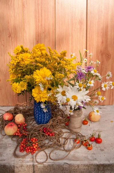 Two bouquets of wild flowers and apples — Stock Photo, Image