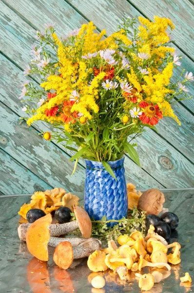 Still life of yellow flowers bouquet in the blue vase with mushrooms — Stock Photo, Image