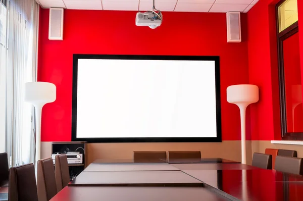 Conference room with a white screen — Stock Photo, Image