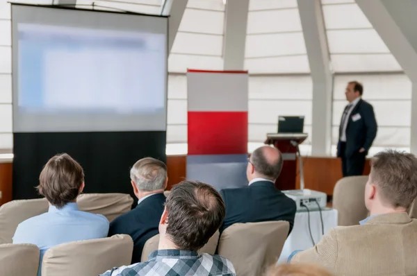 People sitting rear at the business conference and speaker — Stok fotoğraf