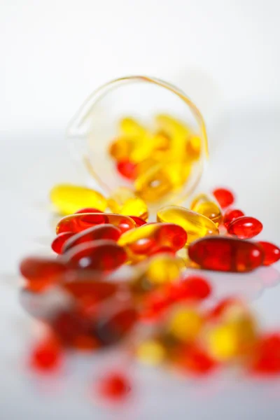 Capsules and Beaker — Stock Photo, Image