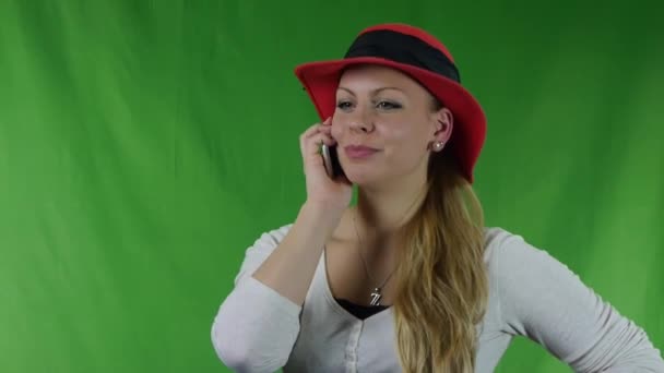 Phoning girl with hat on green screen. — Stock Video