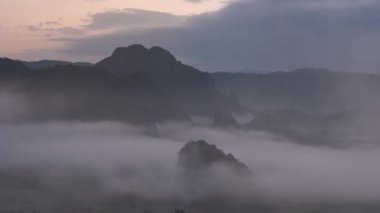 The morning fog on the eastern side saw the movement of orange clouds hitting the sun at Phu Lanka, Phayao Province, Thailand.