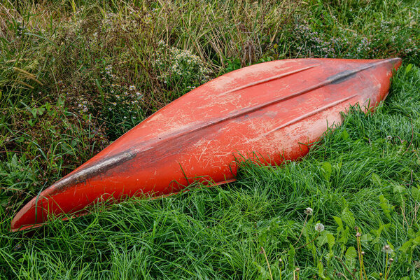 Kayak resting on grassy land away from water