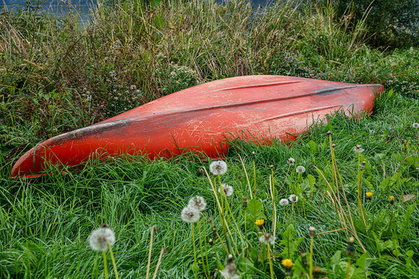 Kayak resting on grassy land away from water