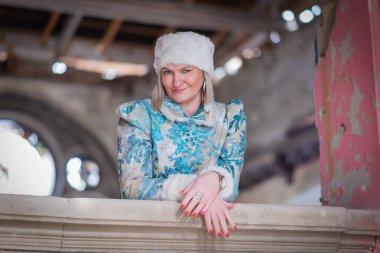 Terk edilmiş bir kalede kış kraliçesi. Kış elbisesi içinde güzel bir kadın.