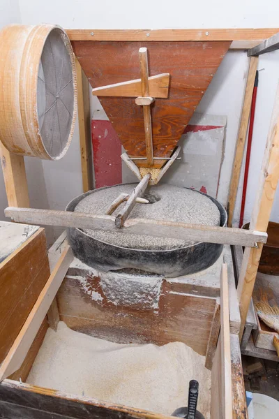 Old flour mill. Interior of a flour mill. Primitive Grain Grinder At A Village.