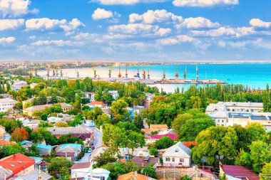 Feodosia şehrinin panoraması ve limanı. Tepeden şehrin manzarası. Şehrin bir kısmında sis bulutu var.