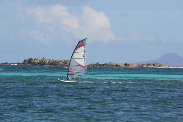 Surfista do Vento com tábua colorida e vela na Praia do Oriente em St. Martin — Fotografia de Stock