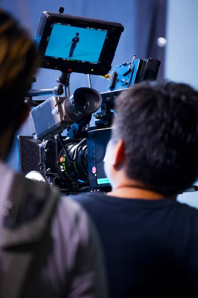 Photographer in studio shooting commercial video