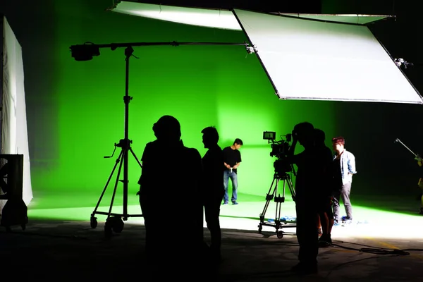 The lighting engineer in the studio is adjusting the lights in the scene