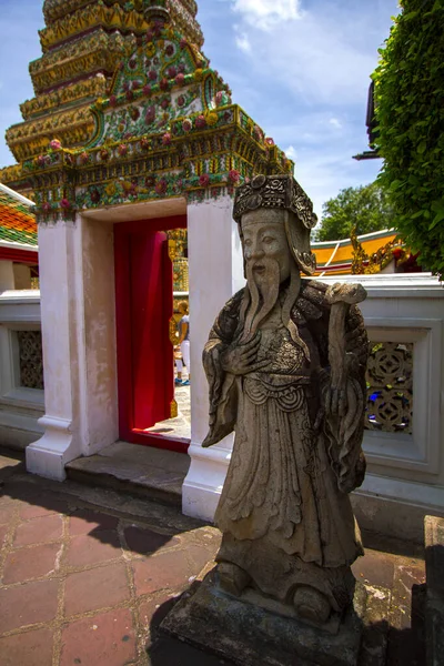 The stone statues in front of the temple gate are carved with Chinese style Shi Zhongweng in Zheng Wang Temple, Bangkok, Thailand