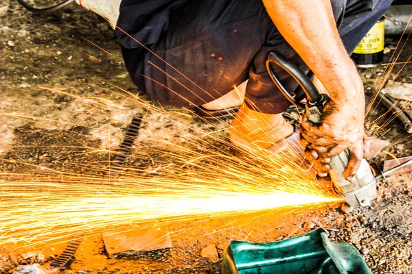 mechanics repairing steel sparks fire light in auto car shop sta