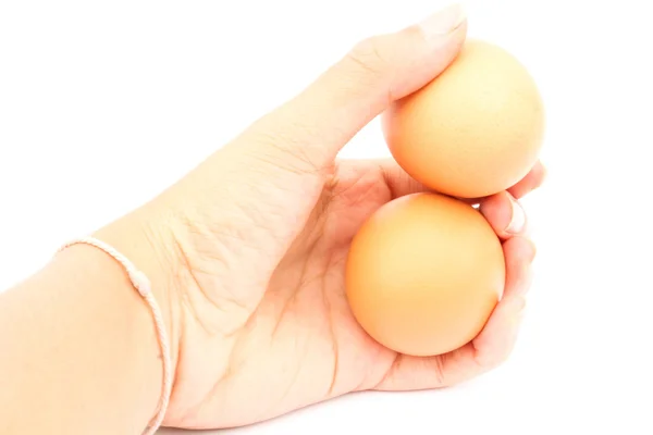 白い背景上に分離されて彼女の手で卵を保持している女性 — ストック写真