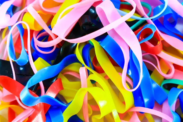 Colorful elastic rubber bands on white texture background — Stock Photo, Image