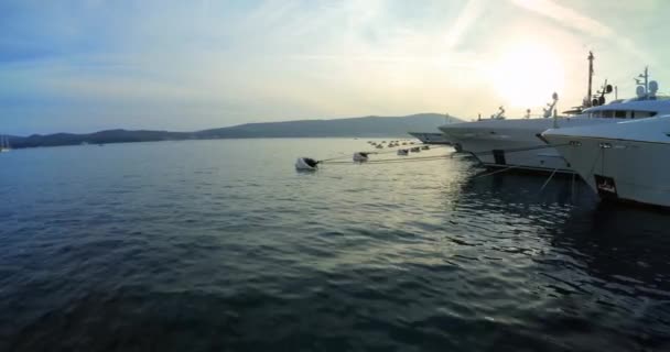 Luxury yachts moored in Porto Montenegro at sunset, Tivat - DCI 4K, Ultra Wide, Pan. — стокове відео