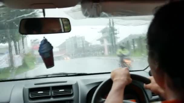 Local man driving the car in the heavy rain in Bali - 4K, Editorial, Audio, POV, Close-up, Handheld — Video Stock