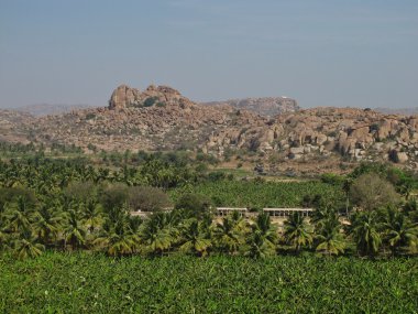 Banana trees, coconut palms and granite mountains