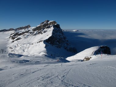 Mountain and sea of fog in the Titlis ski area clipart
